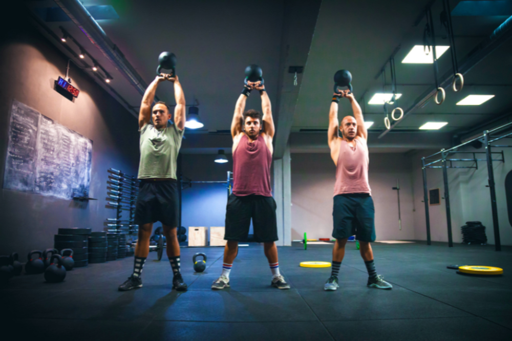 Personal trainer with clients working out with dumbells