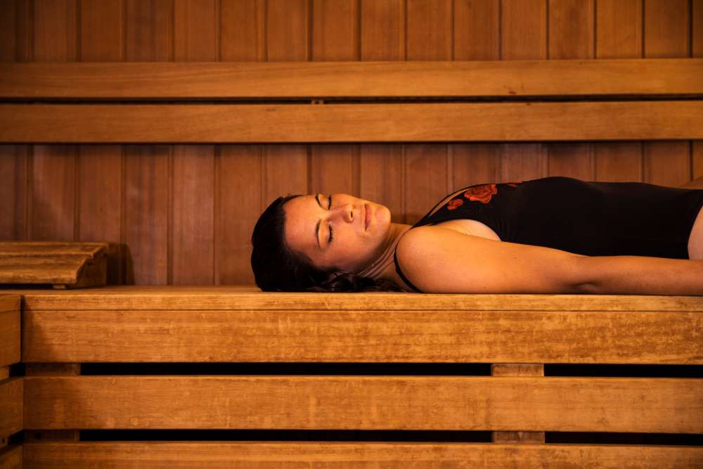 Woman taking care of her well being through a sauna session