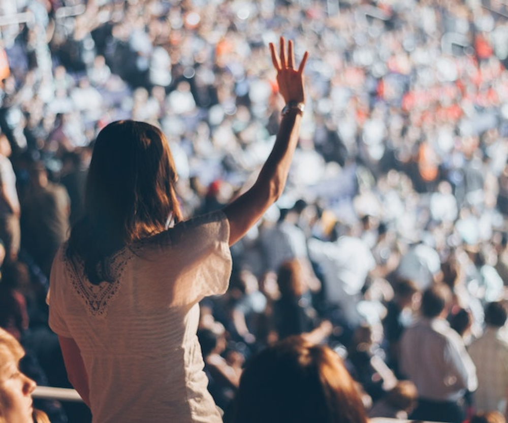 Woman With White Shirt Raising Her Right Hand
