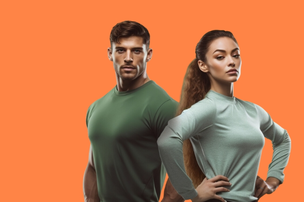Man and woman personal trainers posing on the orange background