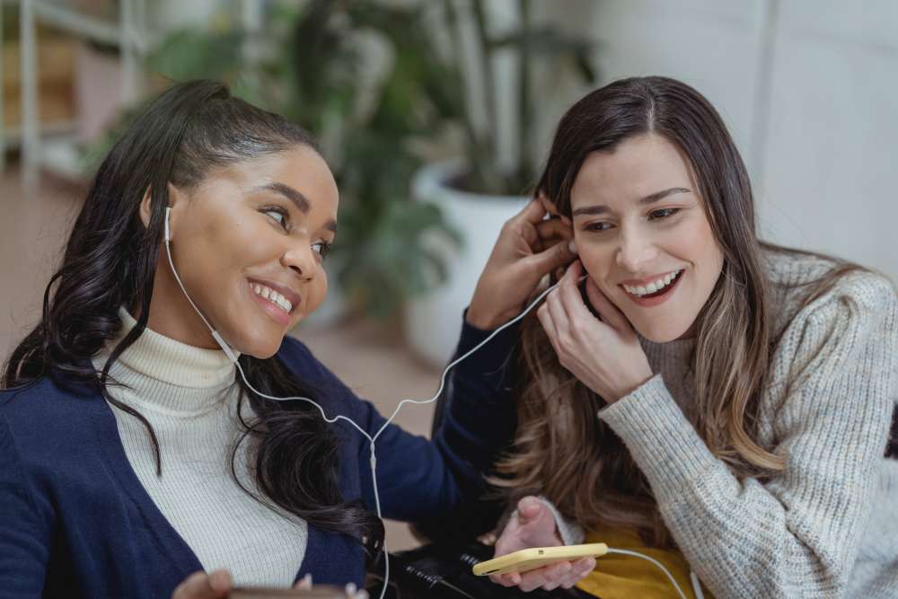 Two woman listening to an entire episode of a podcast together