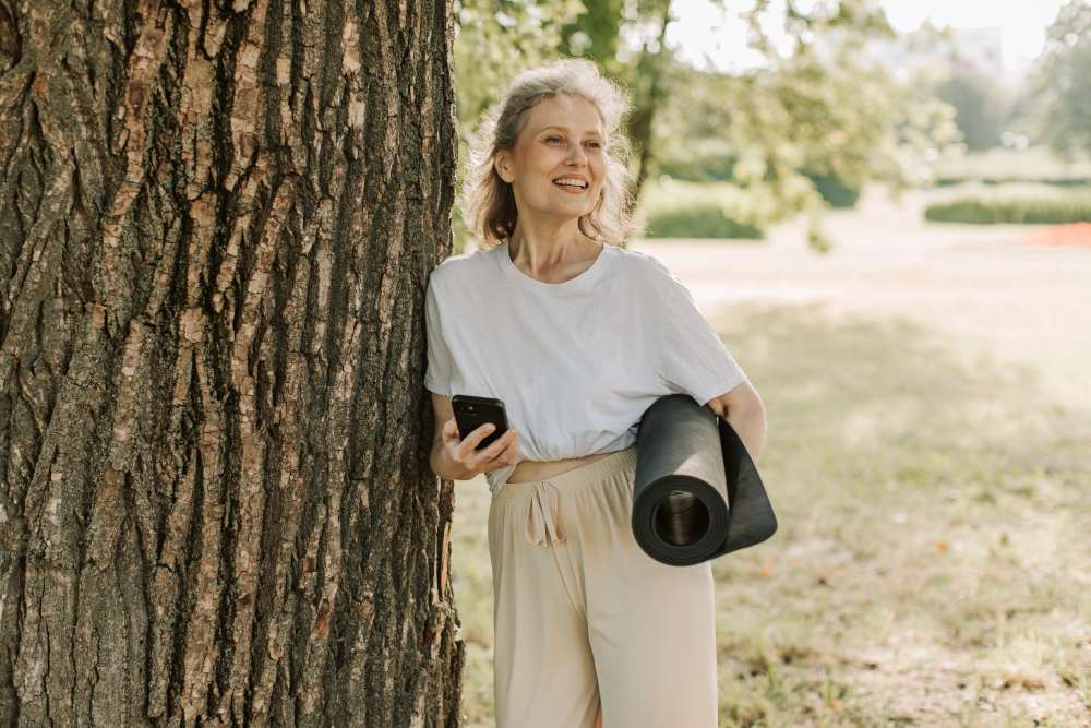 Woman checking her yoga studio newsletter on her mobile device