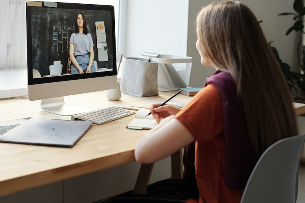 A woman doing an online course on a computer screen