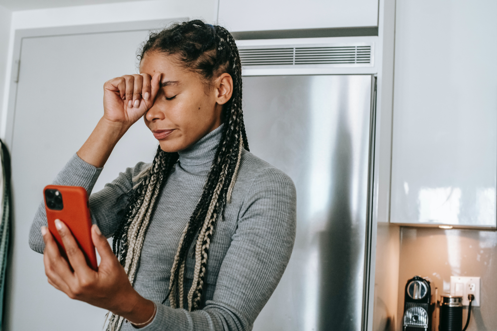 A frustrated woman holding a phone in her hand
