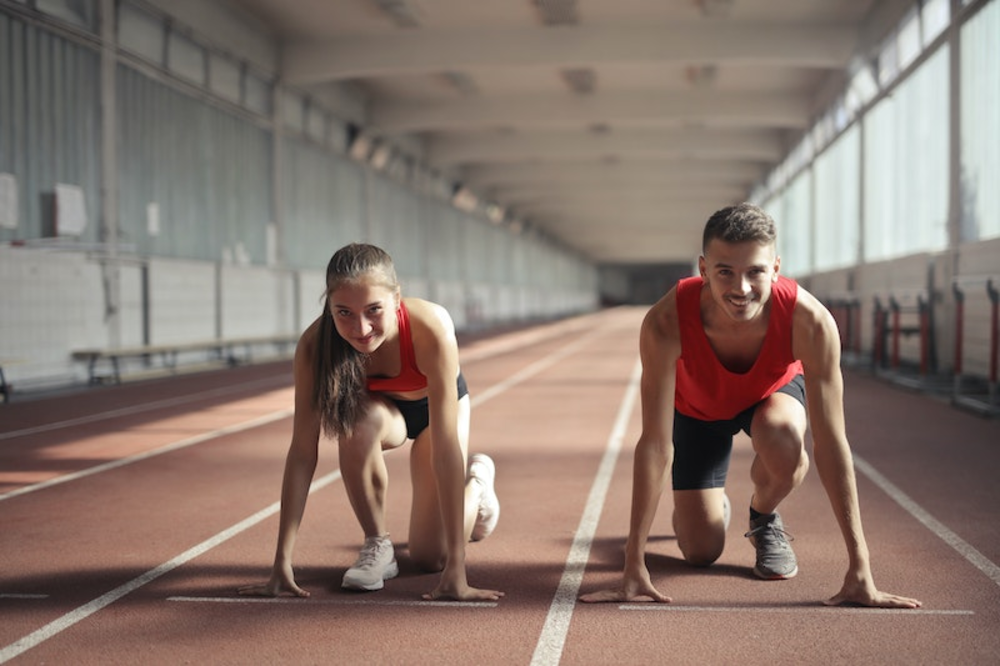Two people at the starting line on a race track