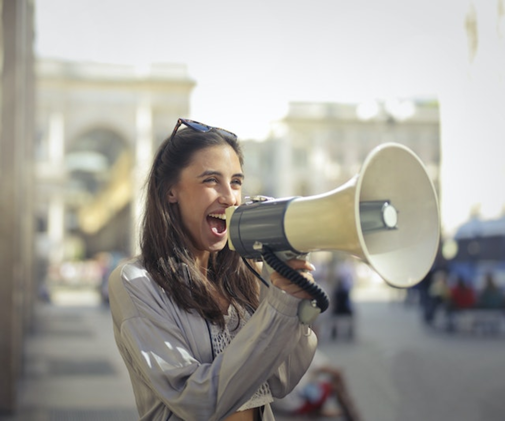 Woman speaks in loudspeaker on the street