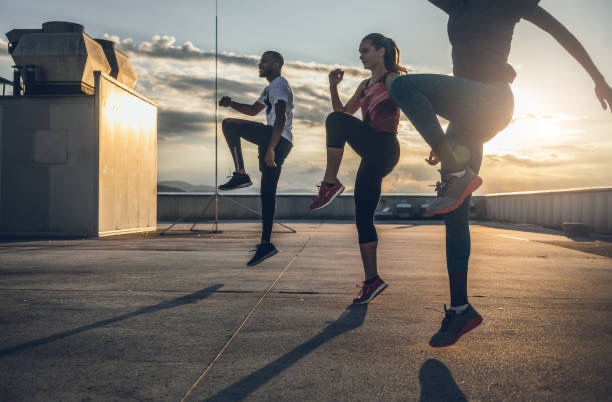 Three people doing workout on the roof terrace