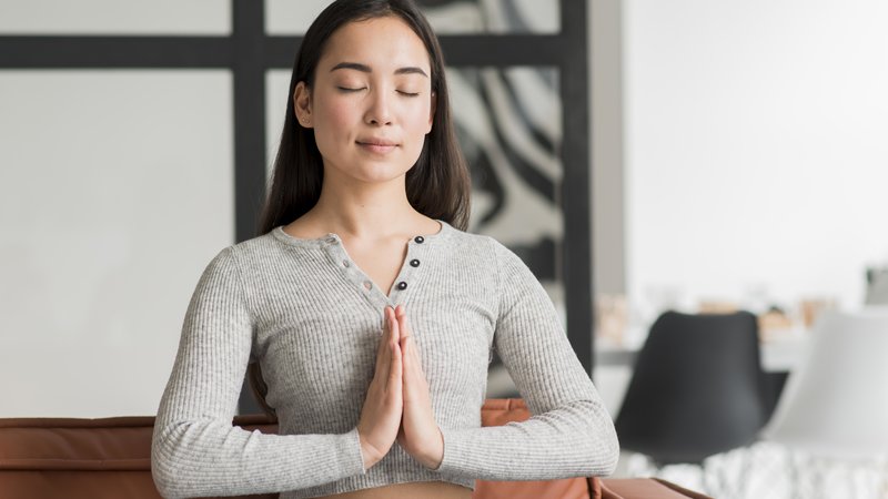 Woman meditating at home