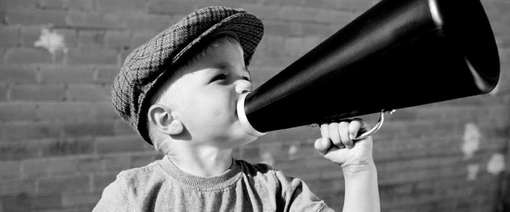 child attracting attention with a megaphone