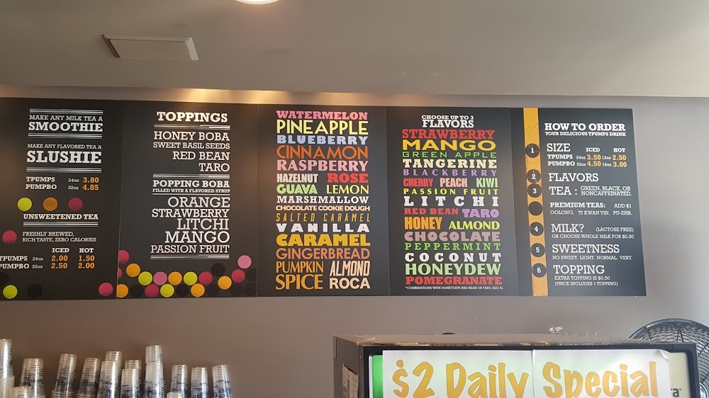The in-store menu board: bright category columns on black.