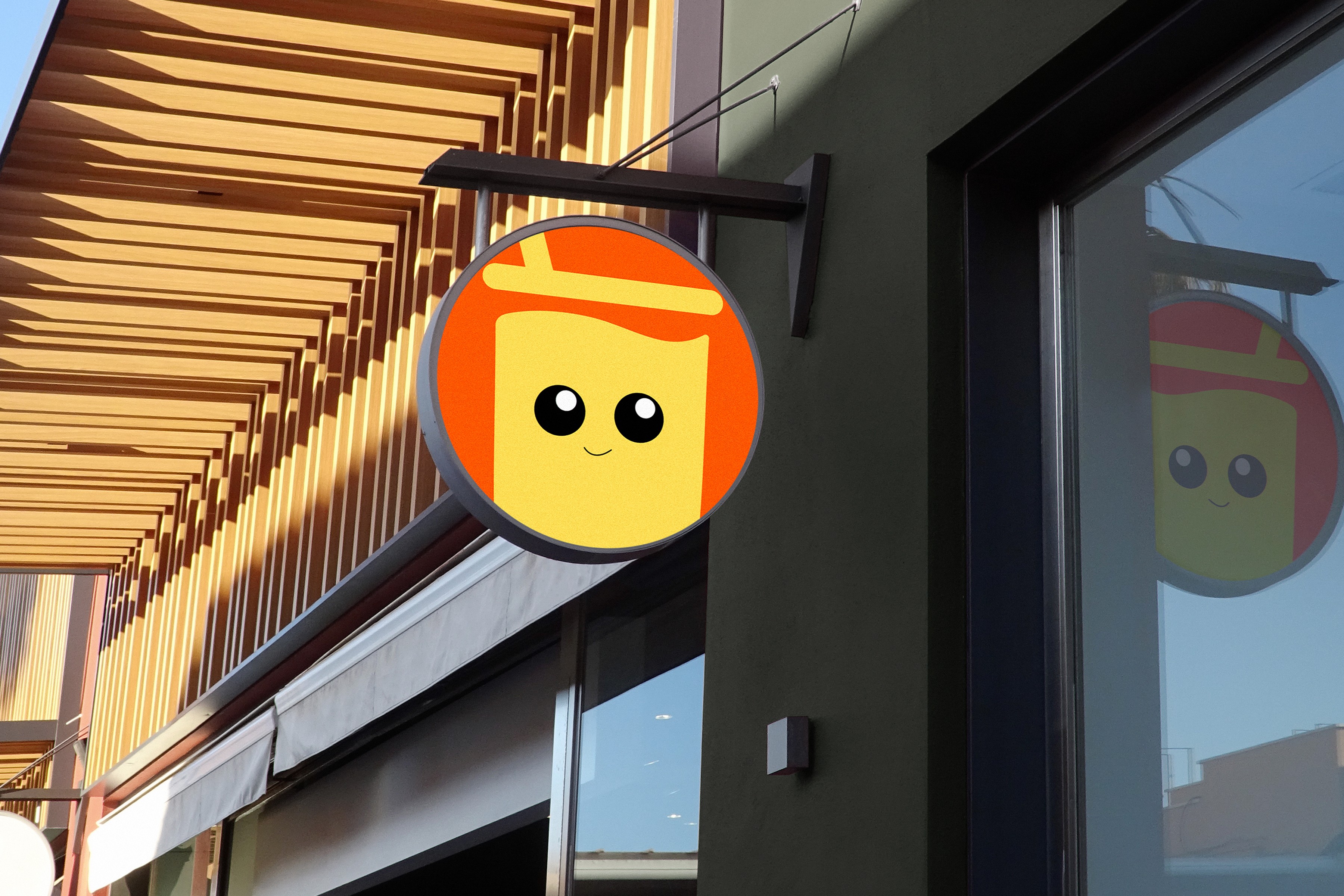 The mark as a round blade sign hanging outside a storefront.