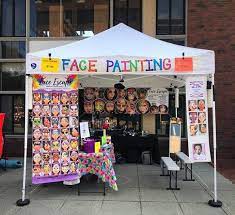 Face painting booth with artist