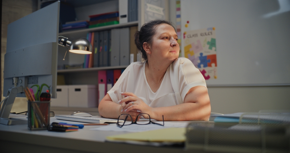 Substitute teacher sitting at desk
