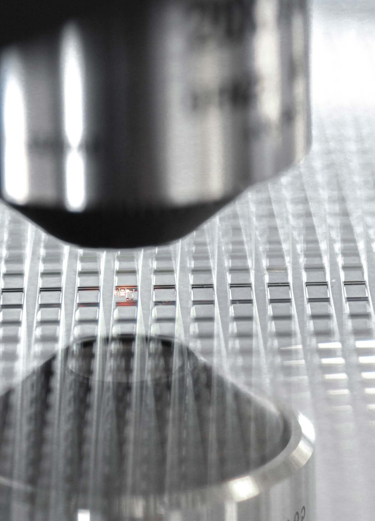Microscope objective positioned over a micro-structured metal surface