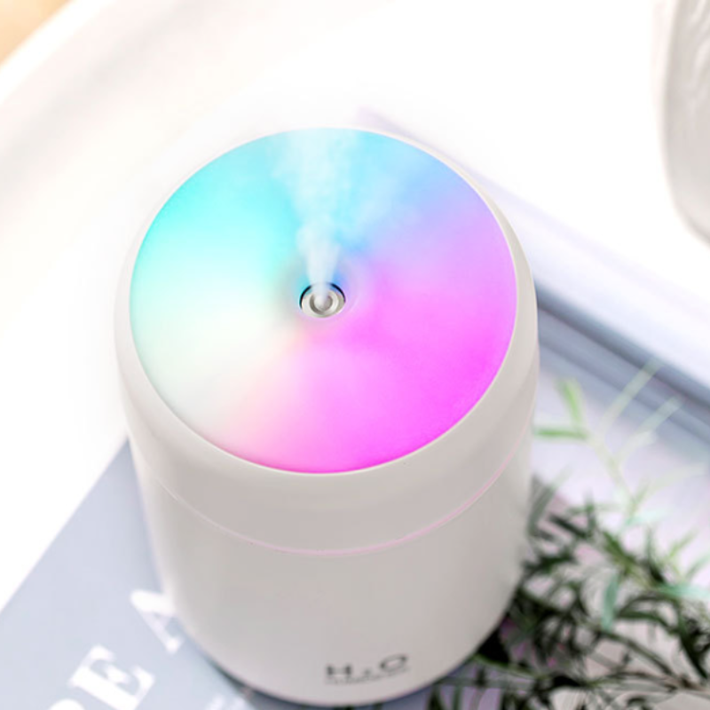 Sleek white essential oil diffuser releasing mist, enhancing relaxation and wellness in modern interiors.
