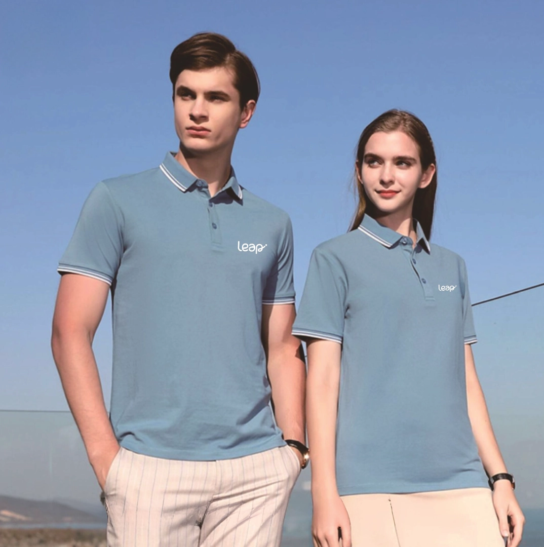 Stylish young couple in matching light blue polos enjoying a sunny outdoor day together.