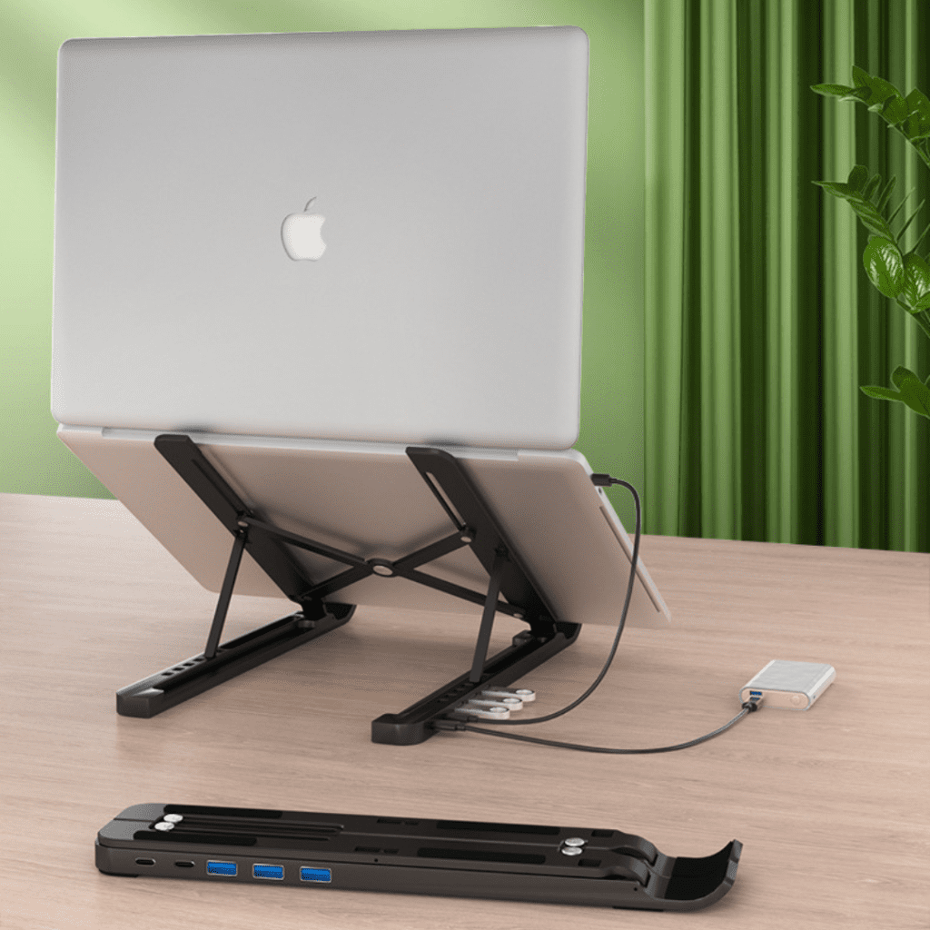 Sleek modern workspace featuring an Apple MacBook, docking station, and vibrant greenery for productivity.