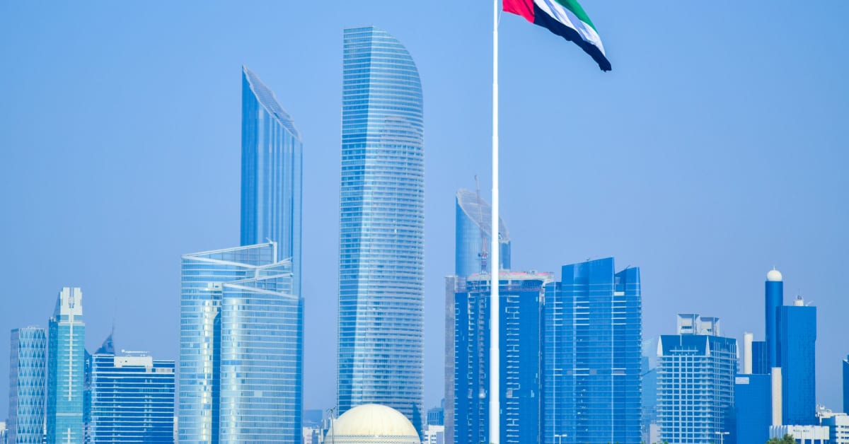 The Abu Dhabi skyline with the UAE flag, host city of the 2026 International Hand & Wrist Congress