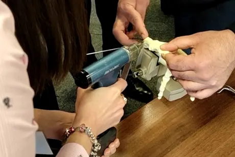 Michelle Razo at the BSSH Instructional Course using a MicroAire surgical instrument