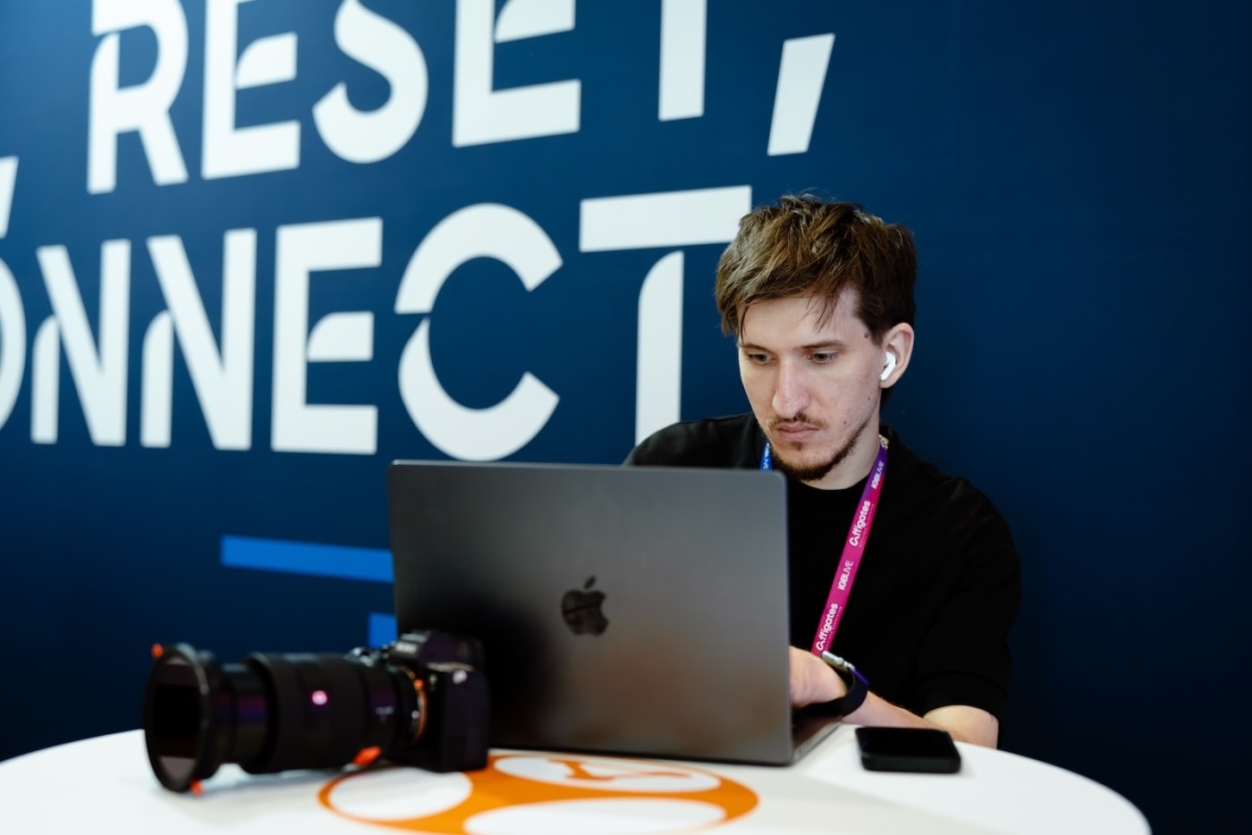 A We Stream editor cutting footage on a laptop at a conference