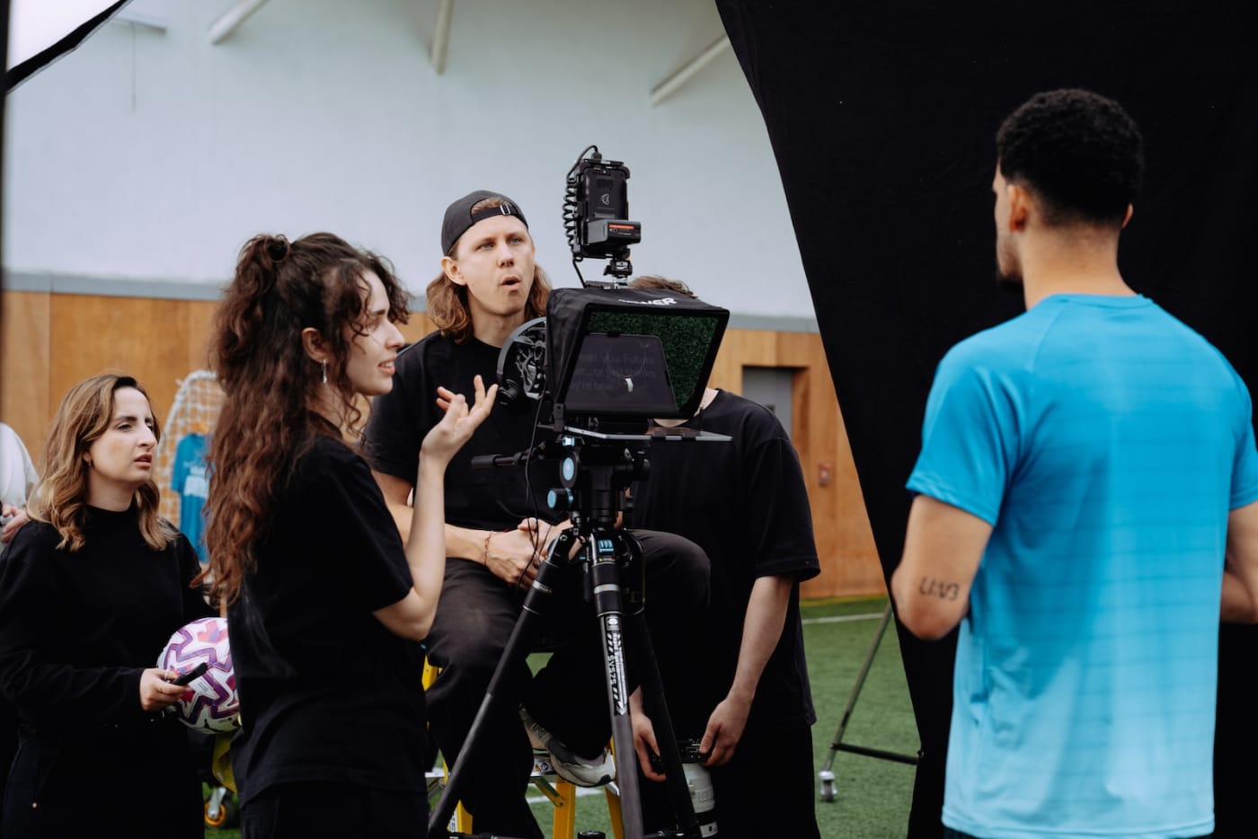 A We Stream crew briefing talent beside the camera before filming