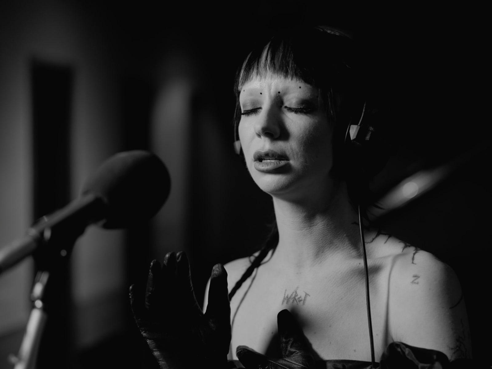 Bambie Thug singing with eyes closed at the microphone, filmed in black and white at BBC Maida Vale Studios