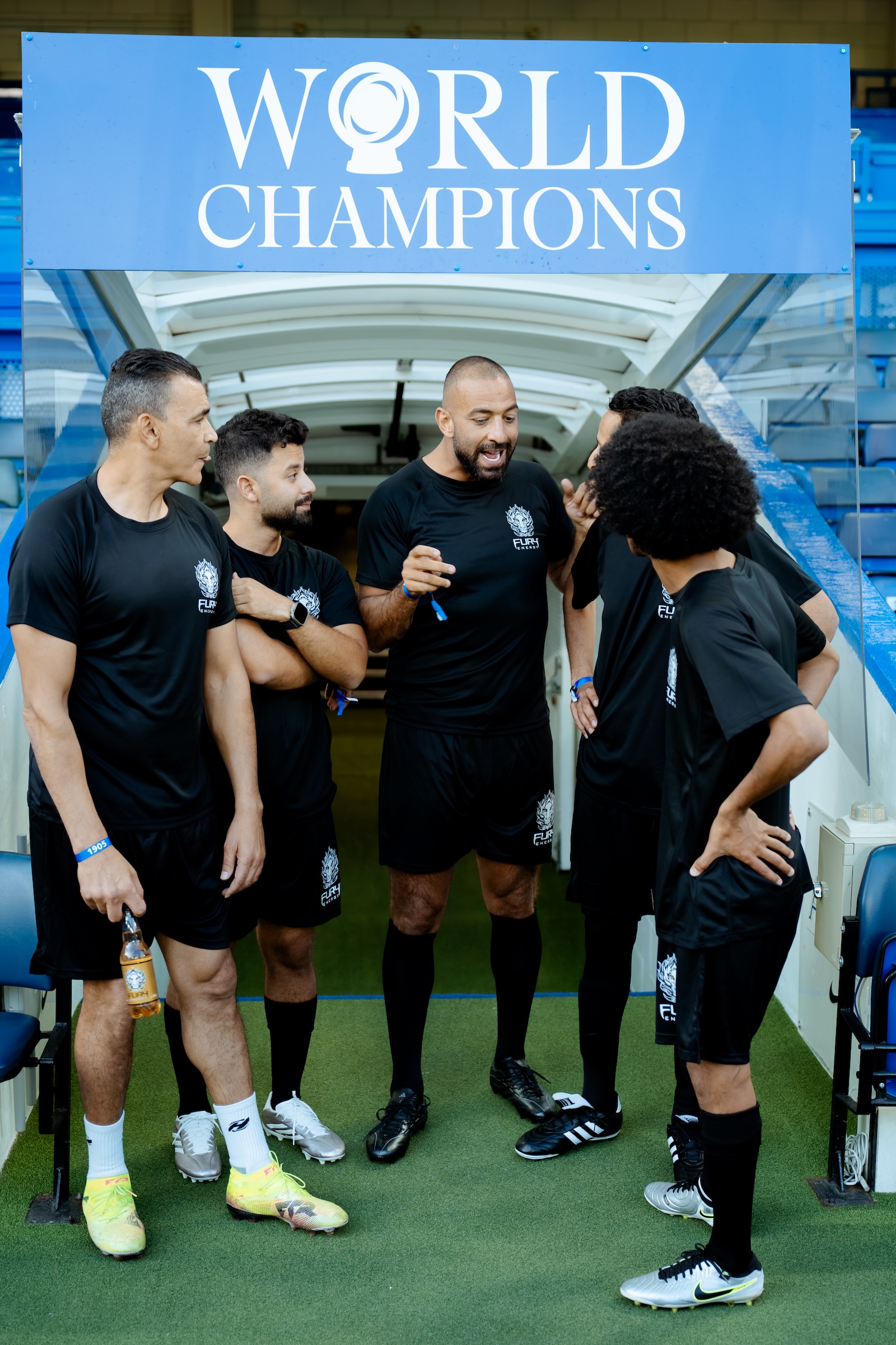 Mido huddled with the Fury Energy team at the Chelsea FC event, Stamford Bridge