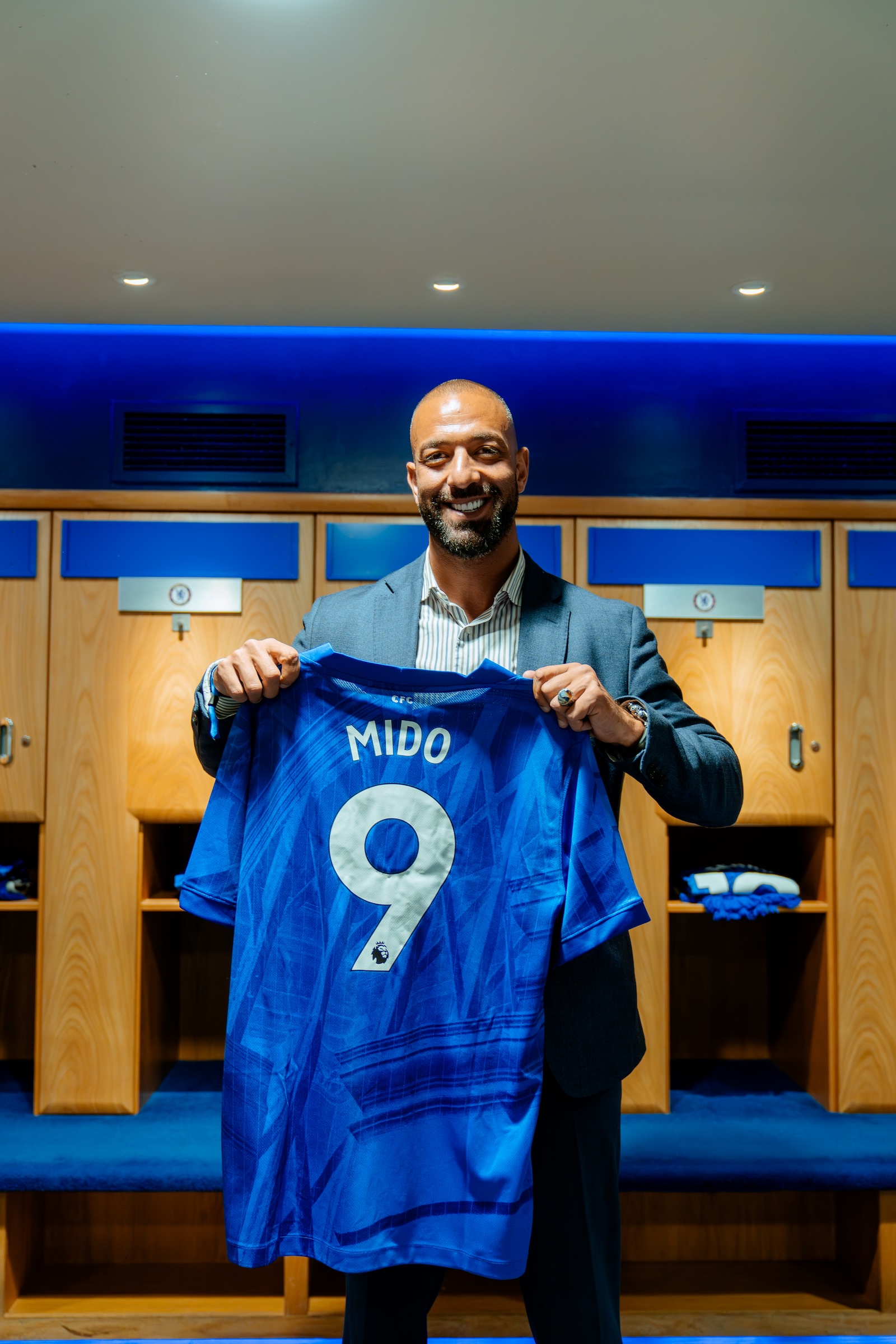 Mido, Egyptian football manager, holding a Chelsea FC shirt at the Fury Energy event, Stamford Bridge