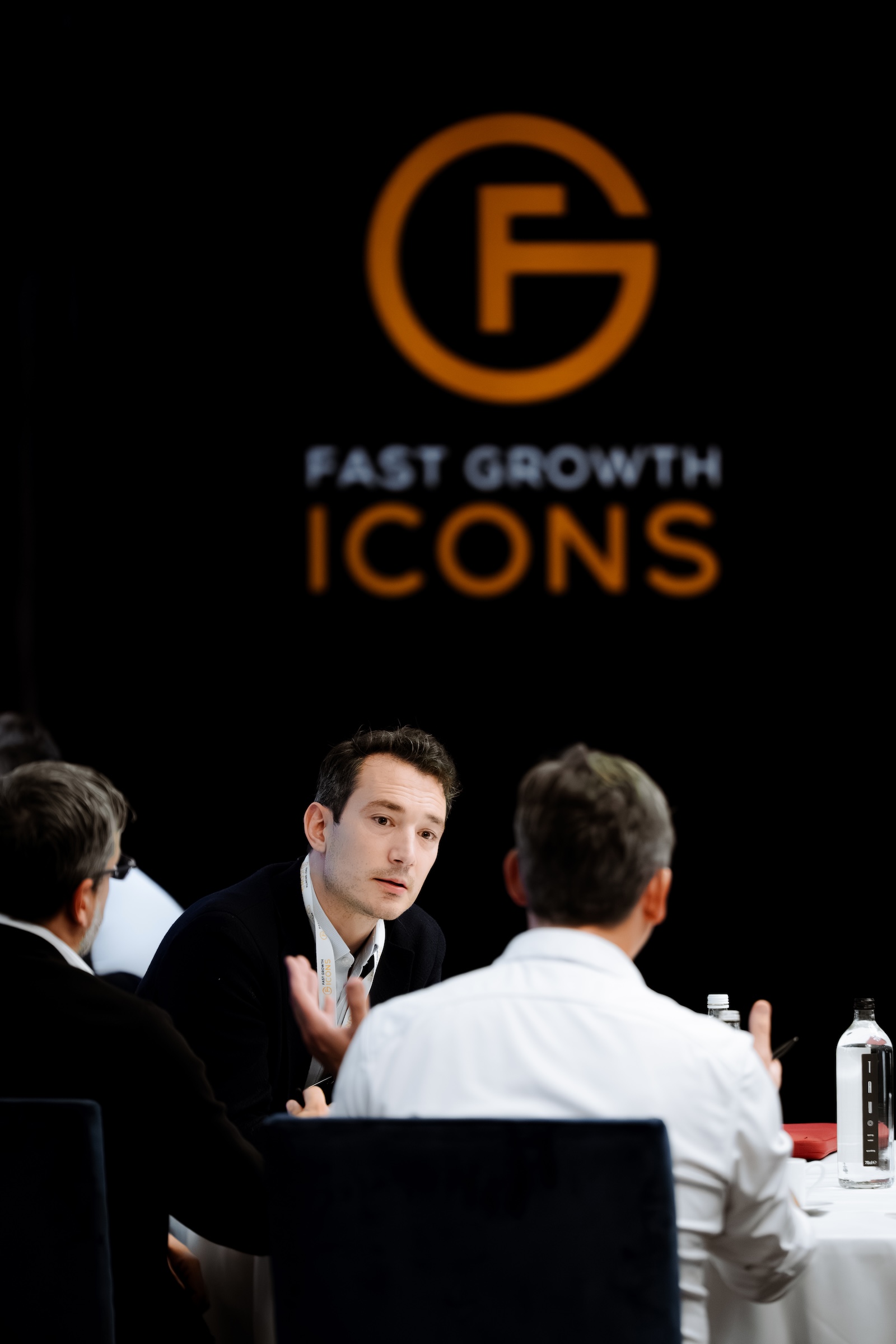 Candid networking conversation at a Fast Growth Icons event, photographed by We Stream