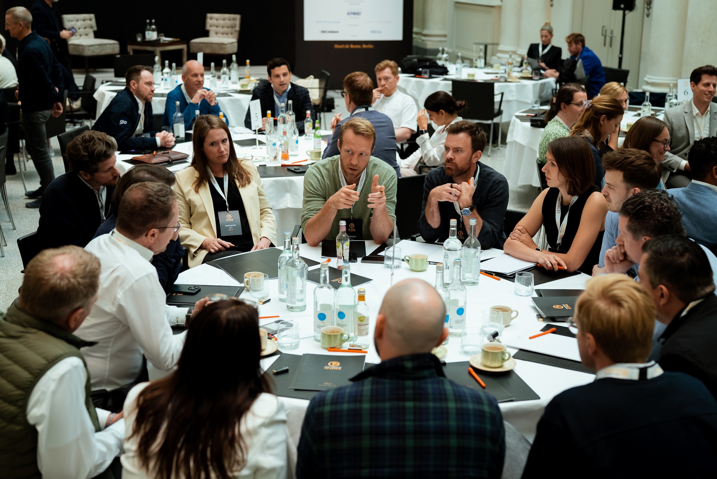 Attendee listening intently during a roundtable discussion at a Fast Growth Icons event, photographed by We Stream