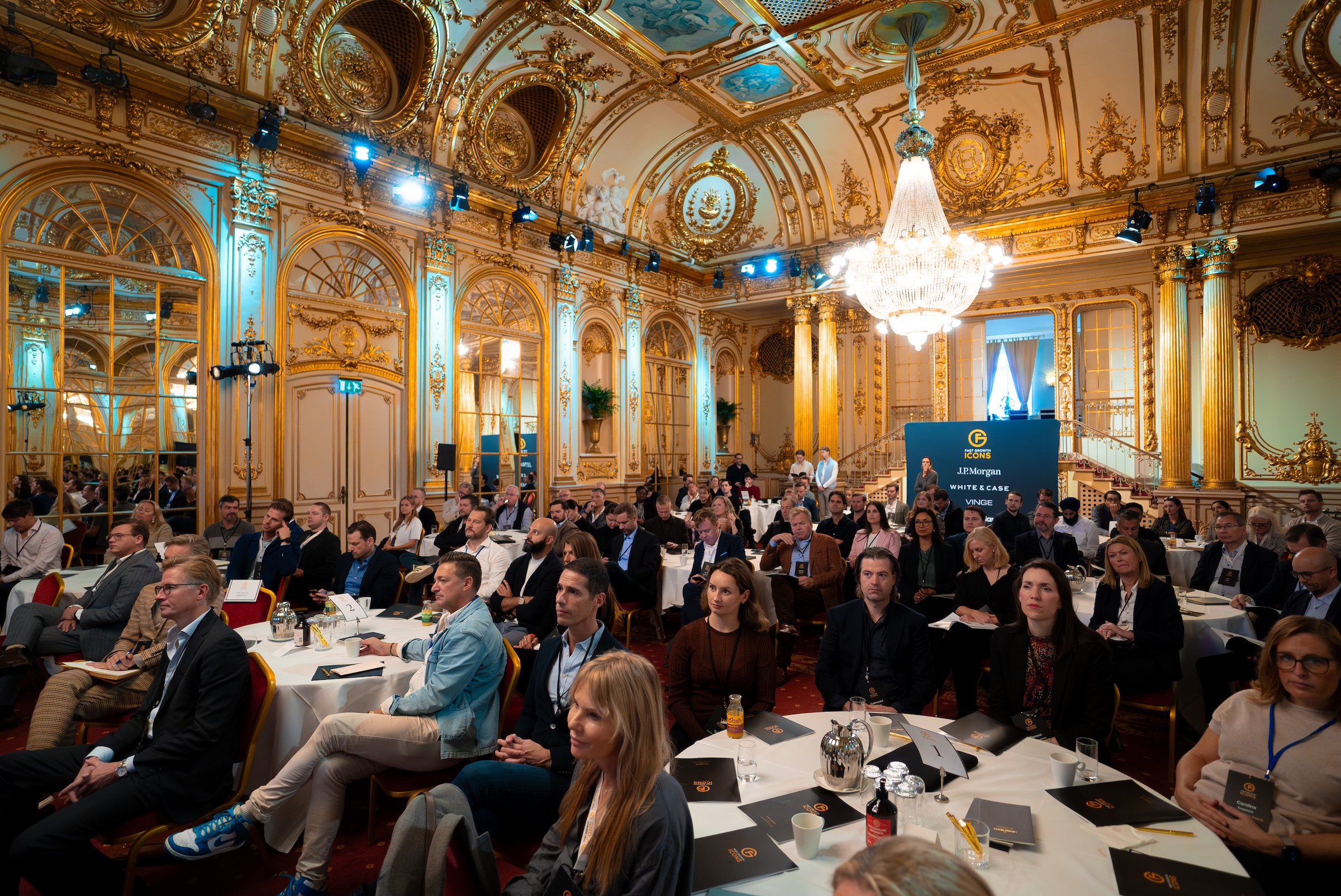 Audience seated in the gold ballroom at Fast Growth Icons Stockholm, photographed by We Stream