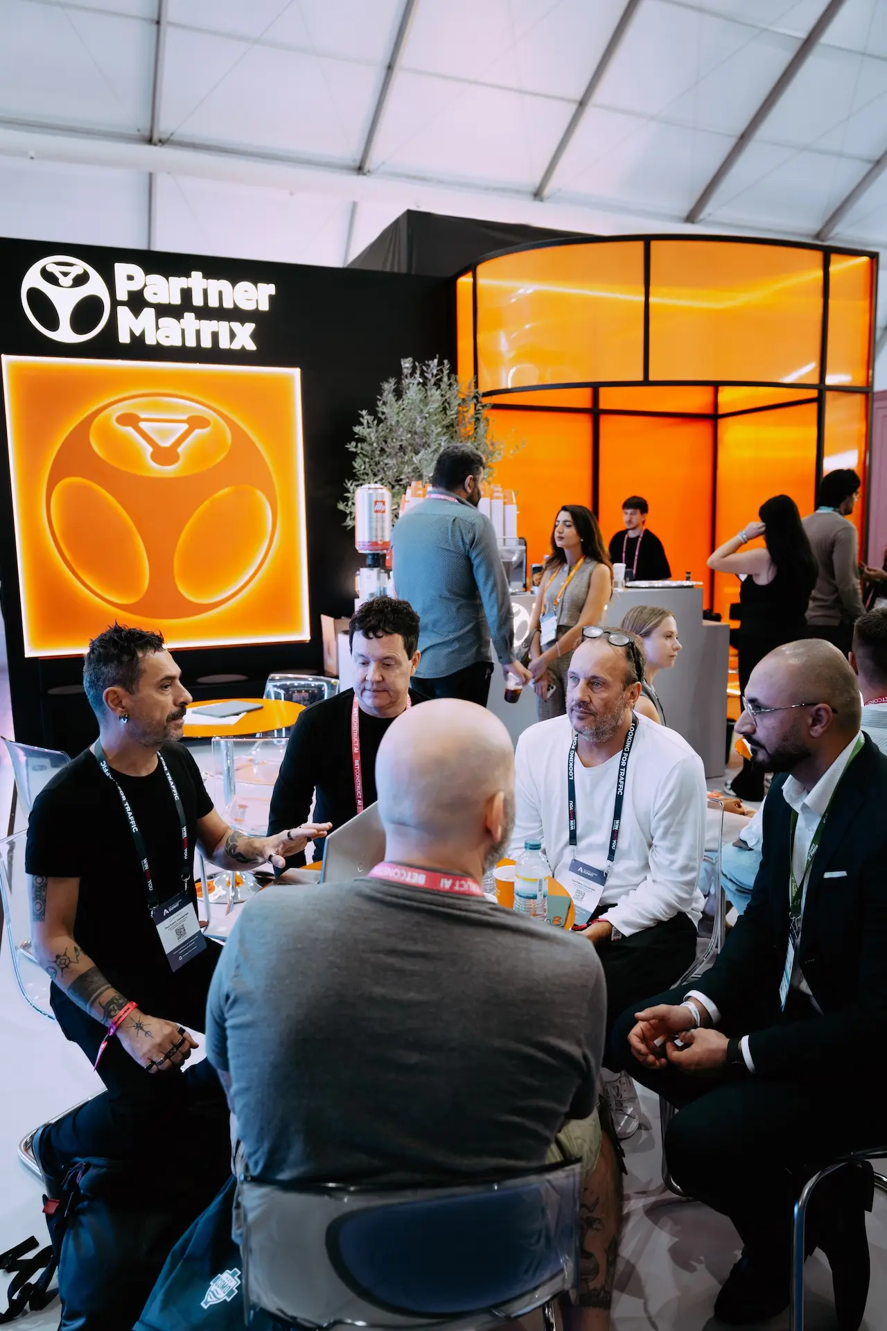 PartnerMatrix team in a round-table meeting under the stand logo at SBC Summit Lisbon 2026