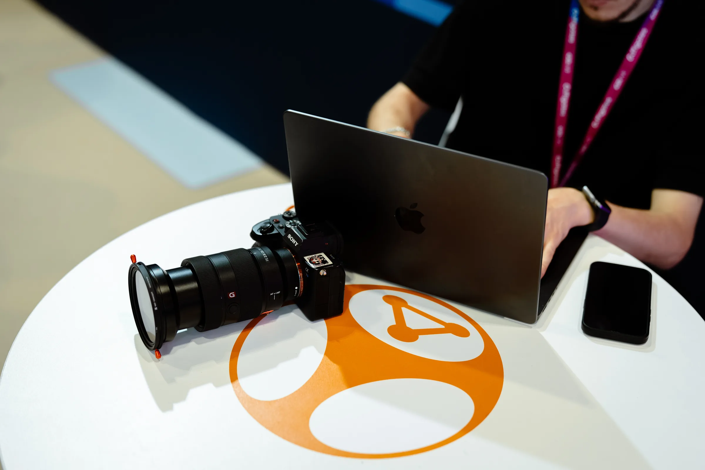 A camera body and a laptop on a stand, between setups