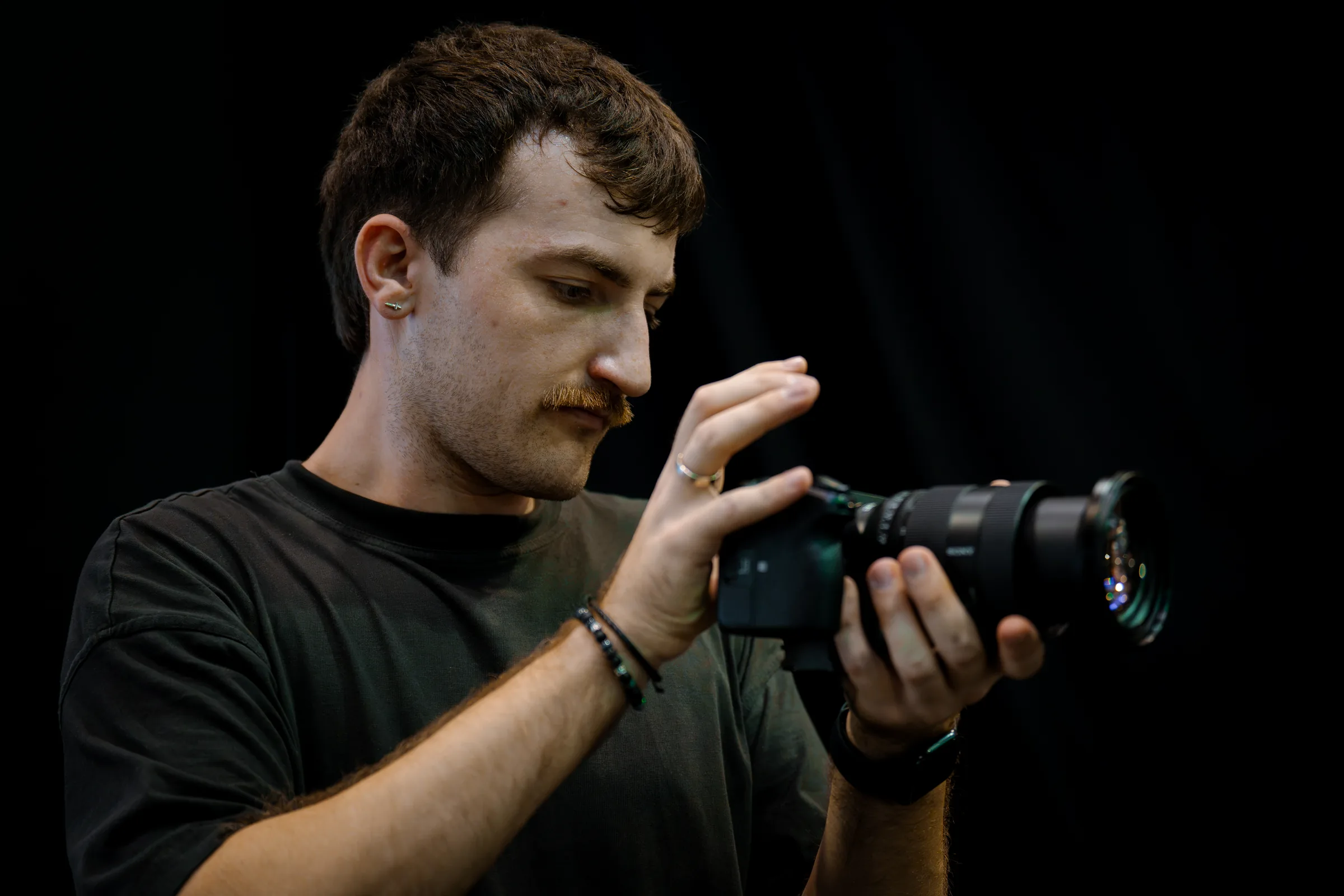 A camera operator checking a lens before a shoot