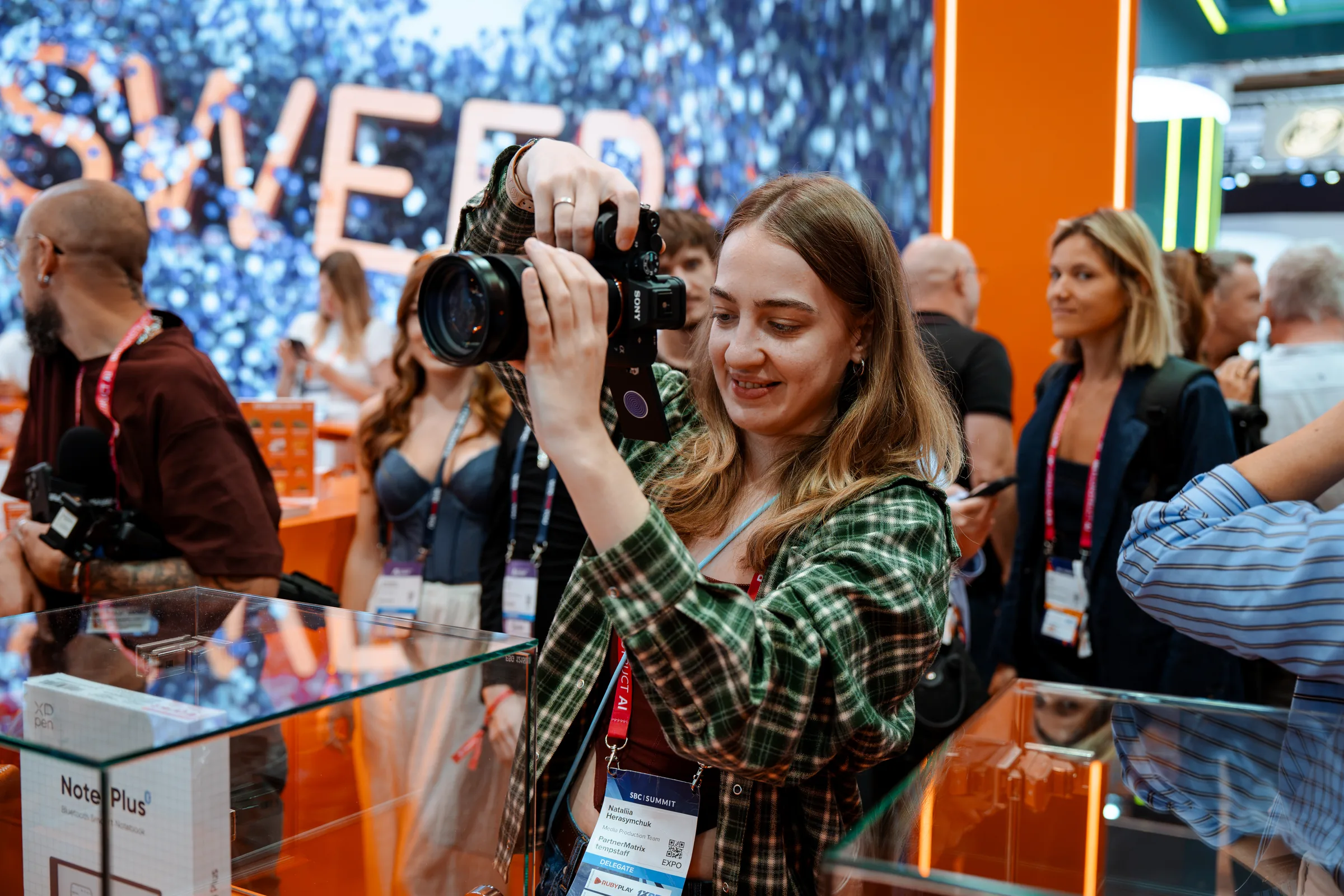A photographer shooting stills on an expo floor