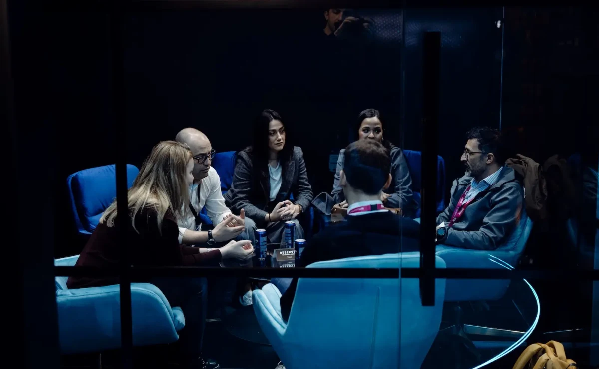 Meeting in a glass-walled room on BitPace's stand at ICE Barcelona 2026