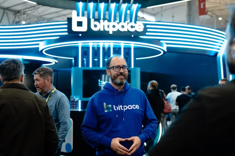 BitPace team member in a branded hoodie in front of the BitPace stand at ICE Barcelona 2026