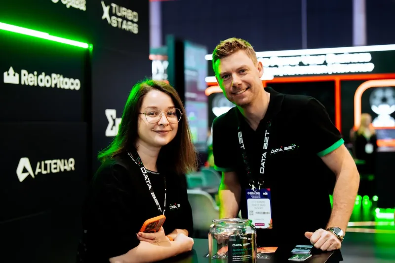 Two DATA.BET team members smiling on their stand at ICE Barcelona 2026