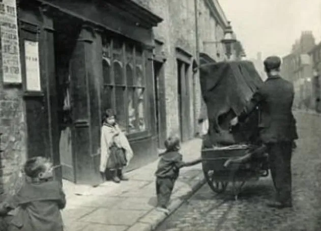 Organ Grinder and children. Photo by Samuel Coulthurst, c. 1894
