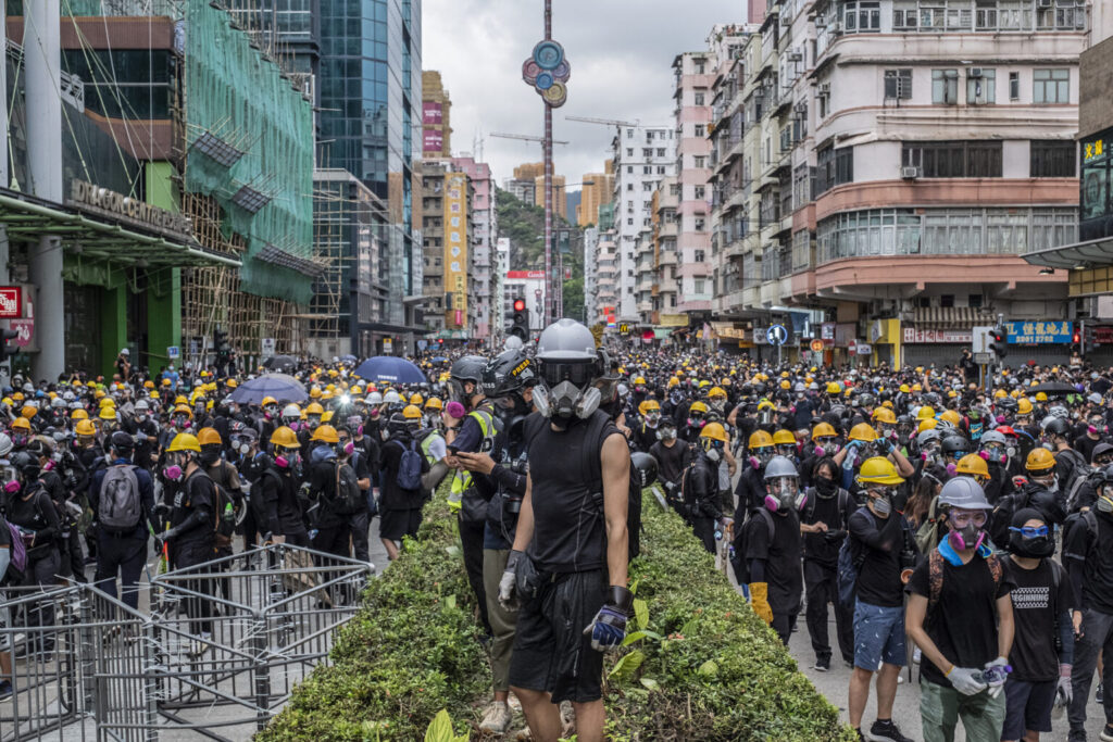Riot police officers fire teargas during clash with protestors outside Shum Shui Po police station in Hong Kong on 11 August, 2019 ©Lam Yik Fei
