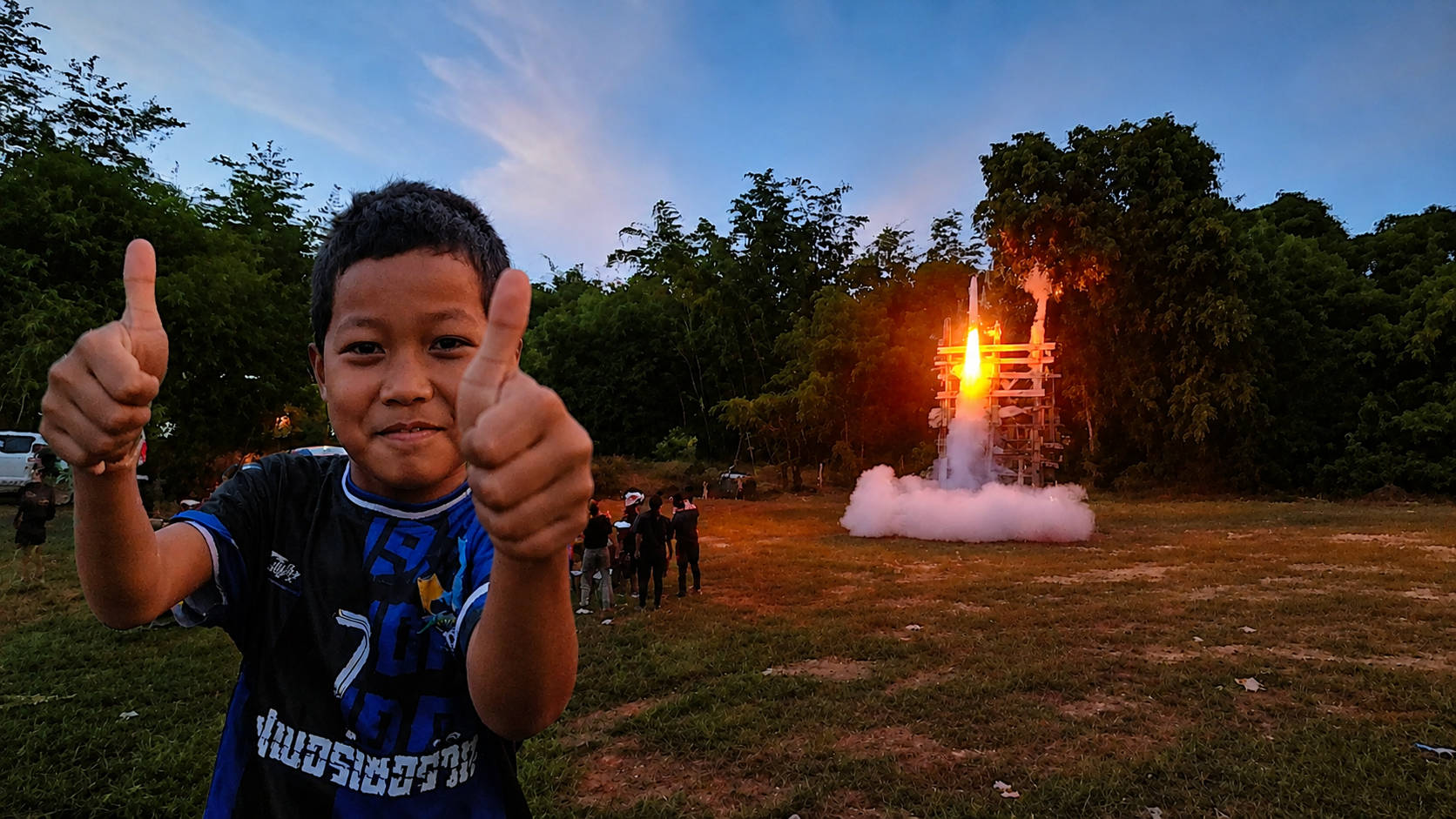 Kid with thumbs up before rocket start