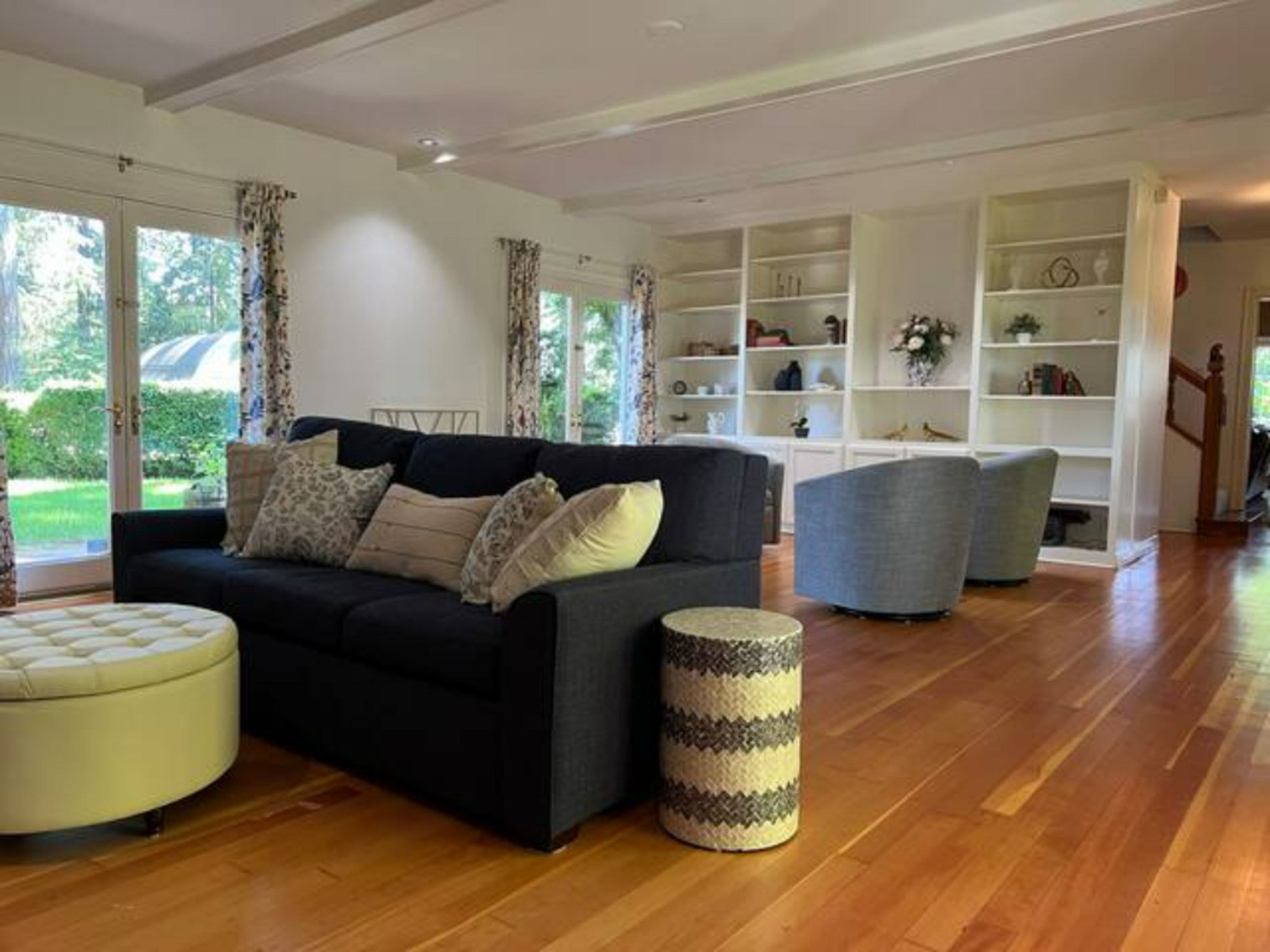 Main house lounge/meeting space with 4 sets of French doors which open to private landscaped property