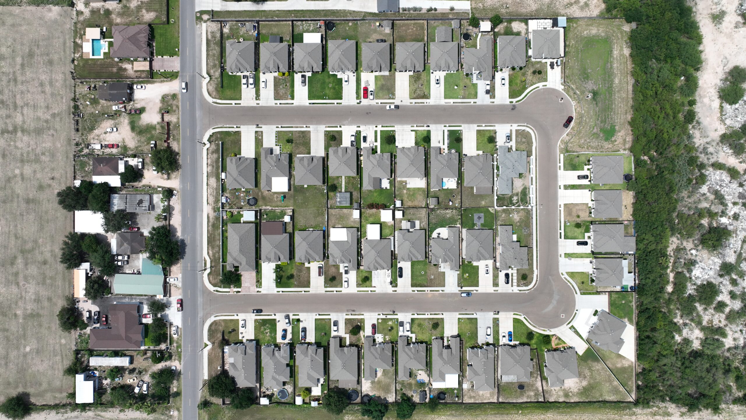 Aerial overview of finished Comarex homes and landscaped front lawns
