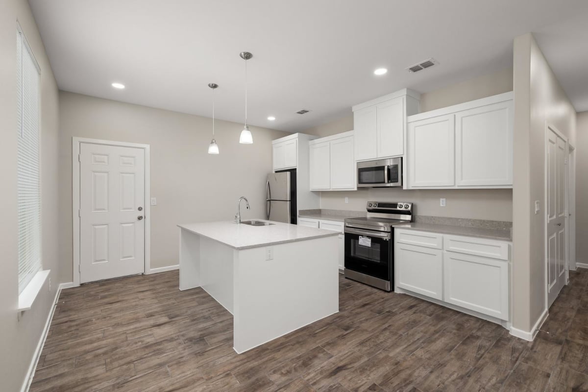 Verona kitchen with white shaker cabinetry, pendant lighting, and stainless steel appliances