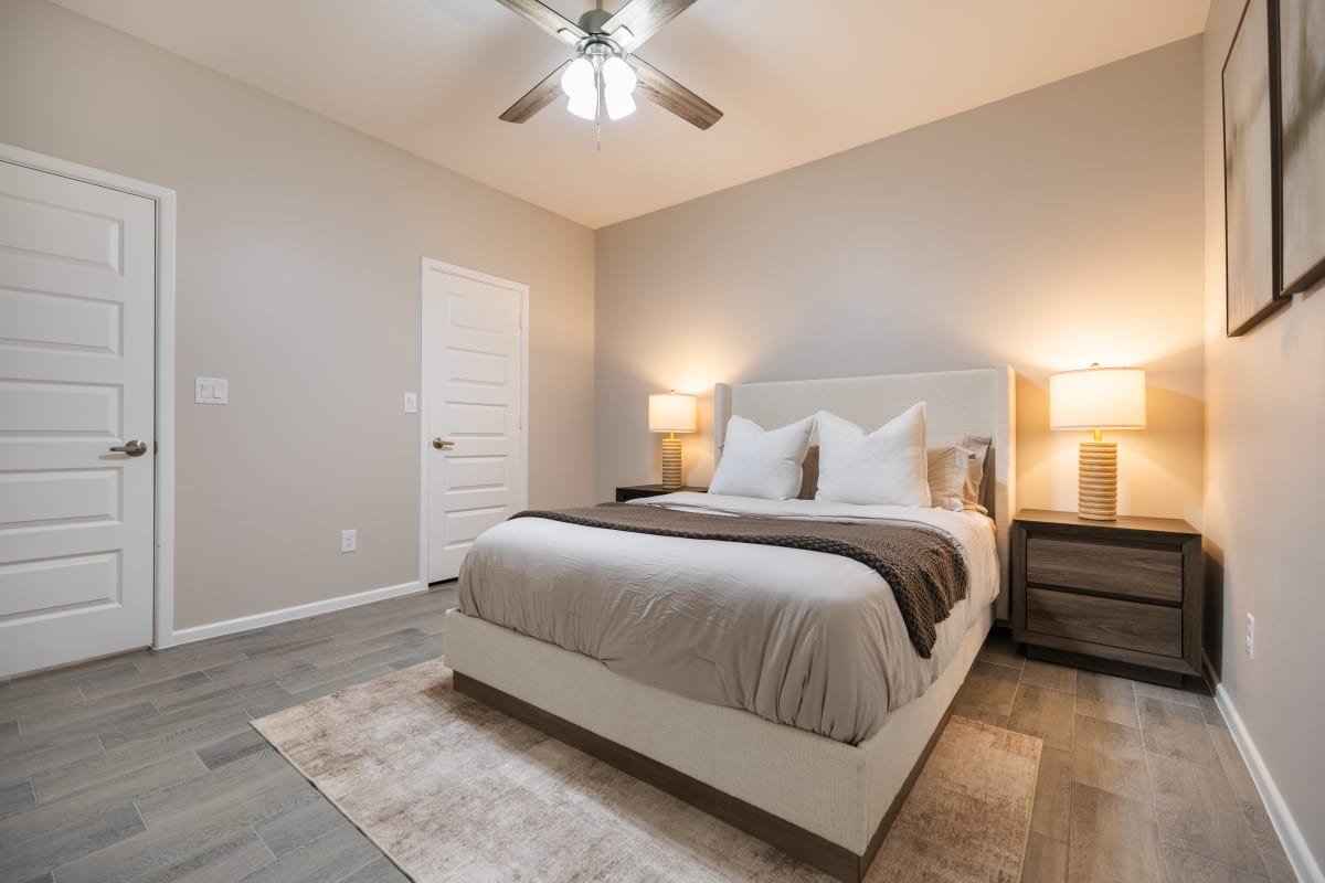 Spacious primary bedroom view showing doors and tile flooring at Westwood Villas