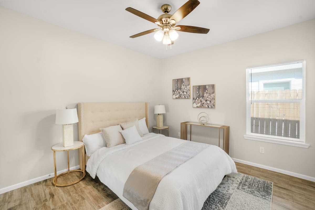 Bright El Dorado bedroom with clean tile flooring and staged double bed