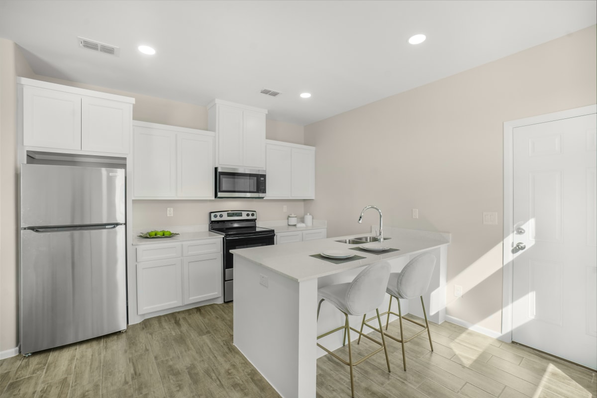 El Dorado open-concept kitchen with white cabinetry, quartz countertops, and island seating