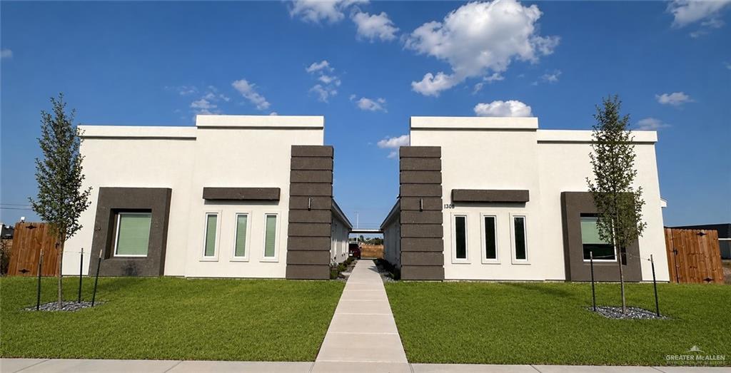 The Heights at Alamo fourplex on Valle Vista Street: two single-story white stucco buildings with dark brown trim and a shared front walk