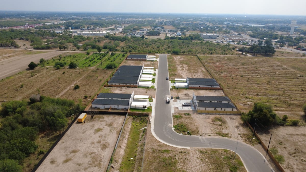 Aerial view of Trosper Creek in Mission, Texas: fourplexes along a new street, with open homesites on either side