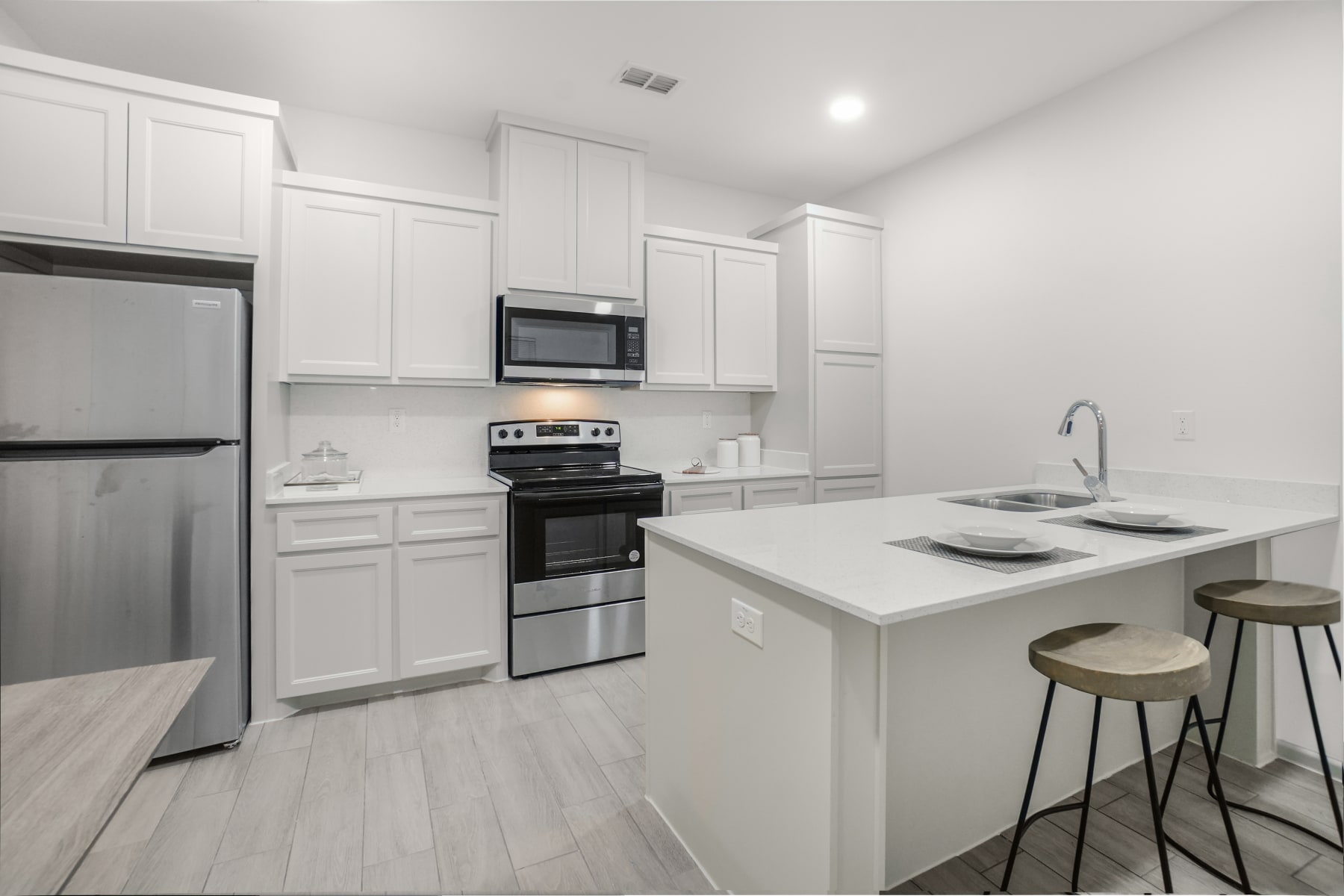 Sugar Mills kitchen island view with clean-lined finishes